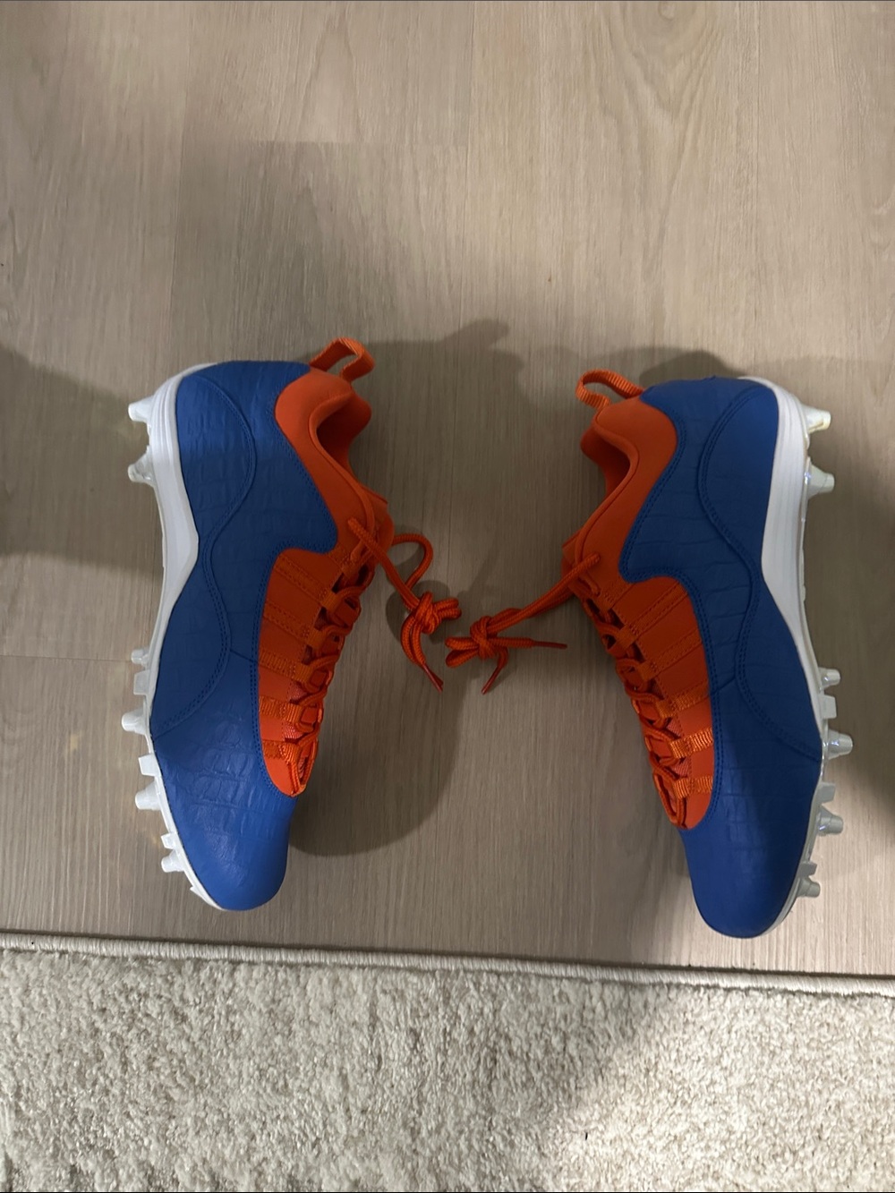 Custom Florida Air Jordan Cleats in Orange and Blue.